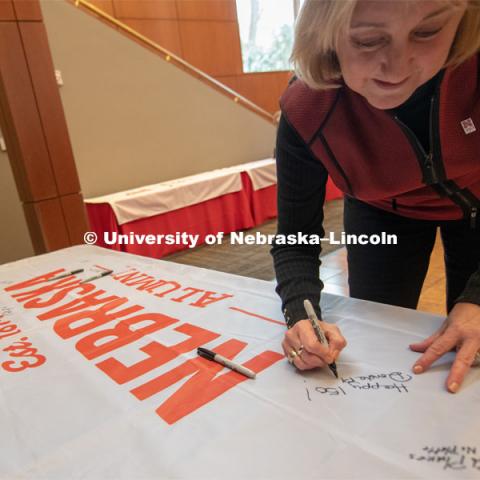 Donde Plowman, Executive Vice Chancellor and Chief Academic Officer, signs one of the four Alumni N150 flags. The flags will travel around the world to various alumni chapters and be signed. They will return in the fall and be hung for homecoming weekend for all to see. Everyone was invited to enjoy a cupcake and join in the festivities with their Husker friends at the Wick Alumni Center, Friday February 15th. The Nebraska Charter was available to view, along with other historical items. Copies of Dear Old Nebraska U could be purchased and signed. Charter Day at the Wick Alumni. February 15th, 2019. Photo by Gregory Nathan / University Communication.